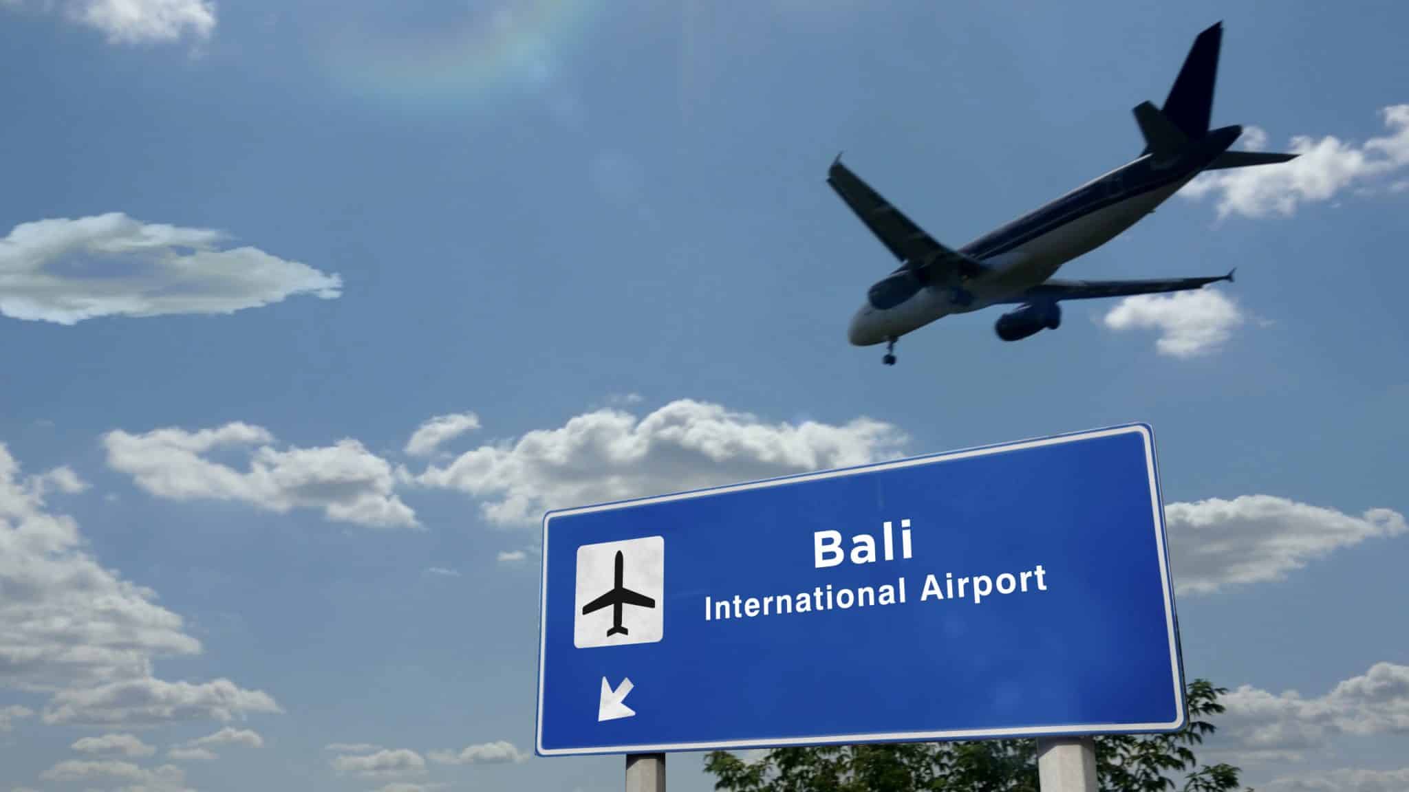 Plane Landing In Bali Indonesia Airport With Signboard